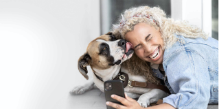 A dog licking her owner's face