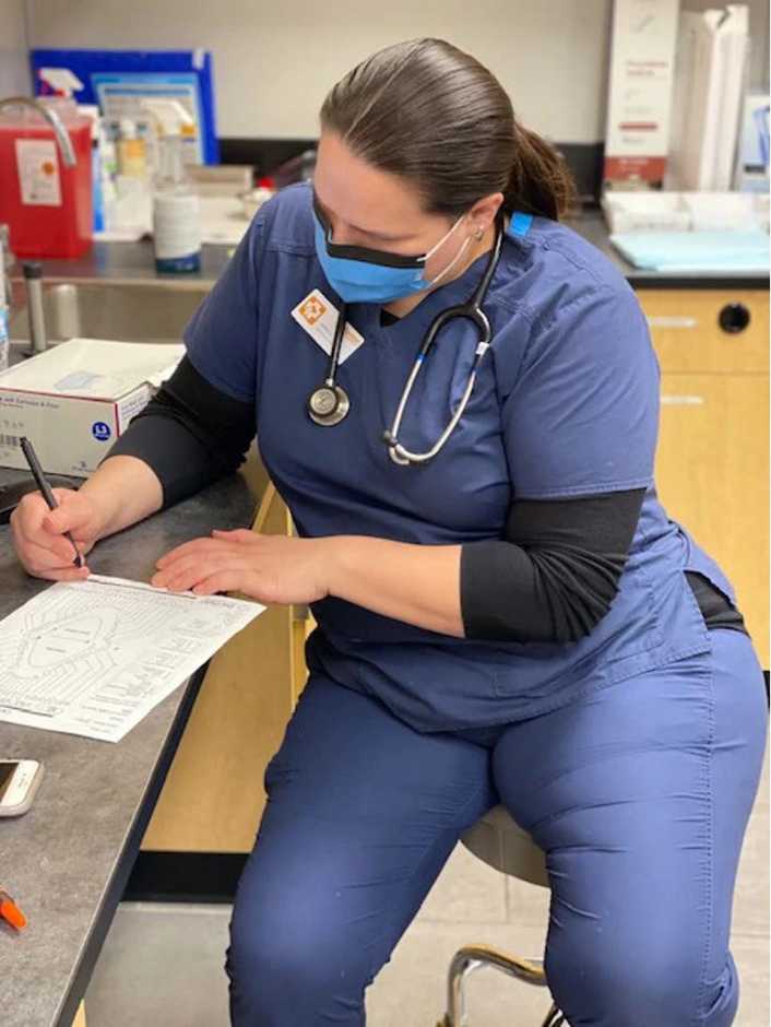 A female veterinarian making notes at the Banfield Pet Hospital